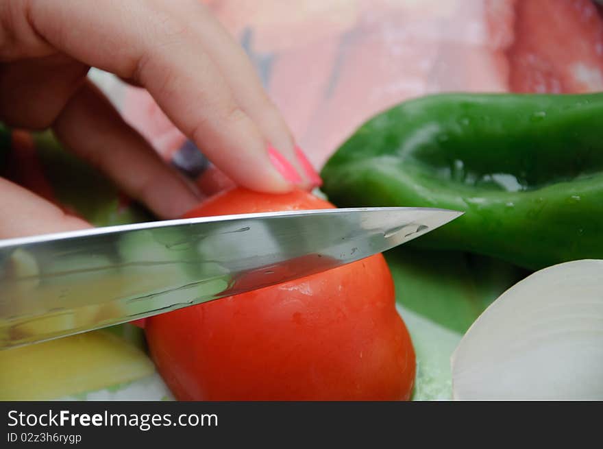 Fresh vegetables on a cut table. Tomato, onion and pepper