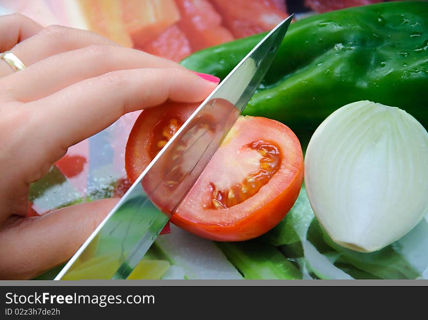 Fresh vegetables on a cut table. Tomato, onion and pepper