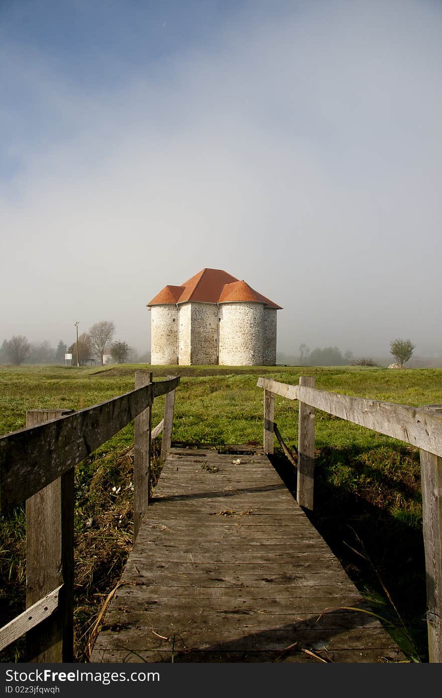 Medieval castle wrapped in a morning fog