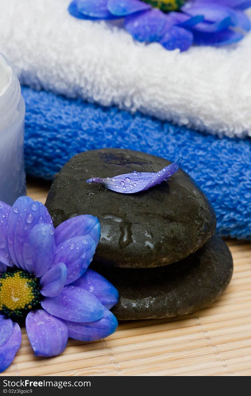 Cream, stones and towel with flowers