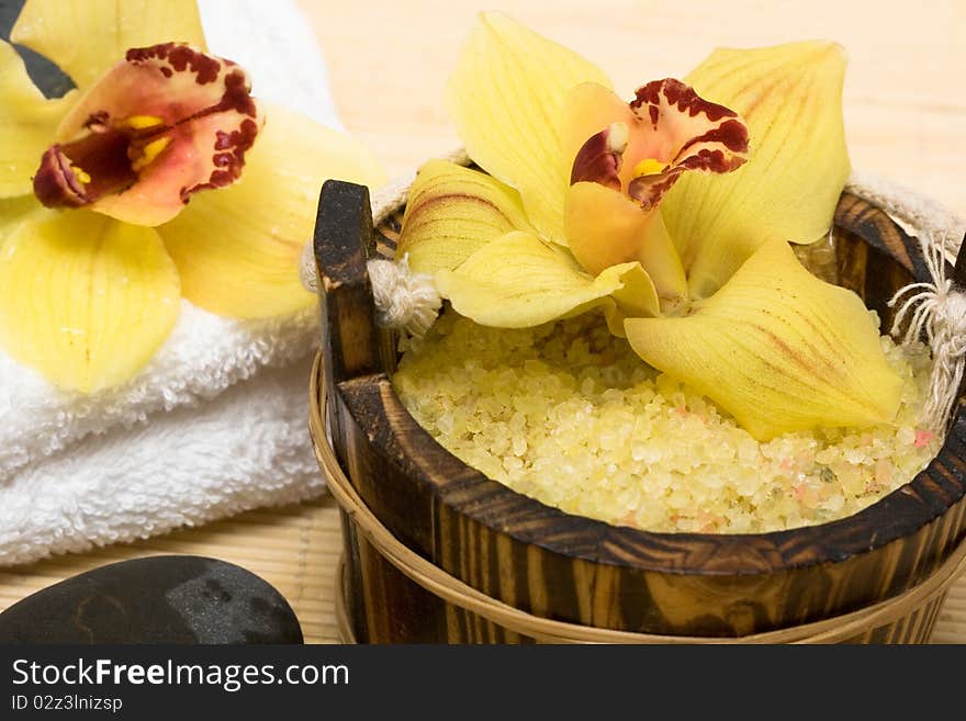 Spa essentials (salt for bath, white towel and orchids)