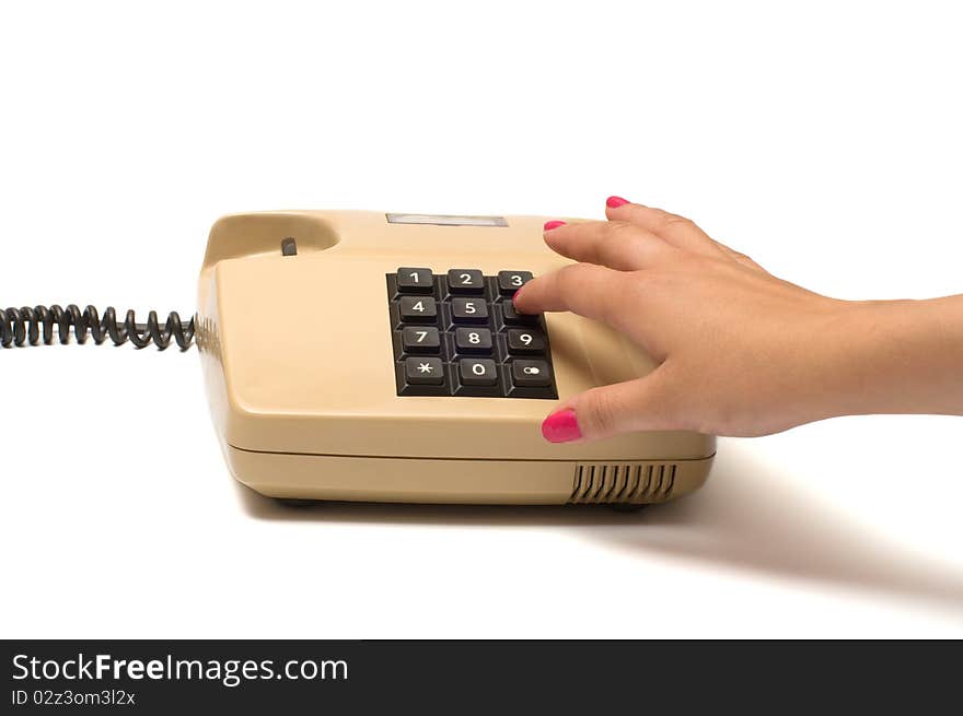 Female finger presses the button on the old phone isolated on white background. Female finger presses the button on the old phone isolated on white background.