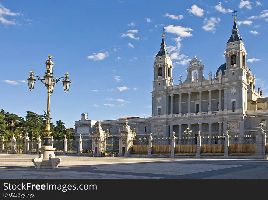 The Nuestra Senora de La Almudena Cathedral facade in Madrid and a golden lamp of the Madrid Royal Palace