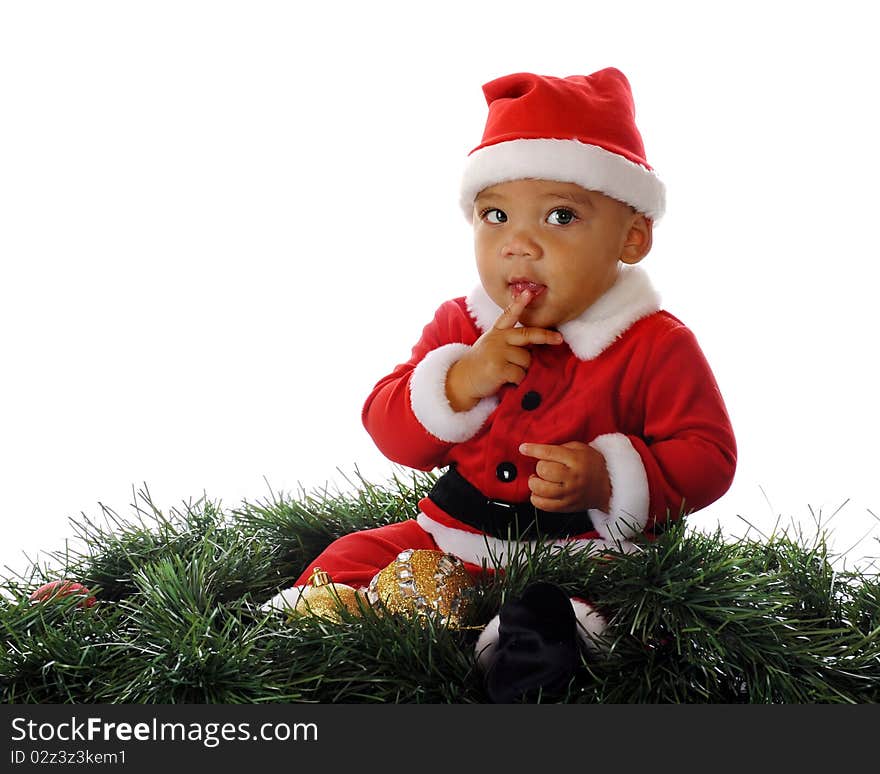 A cautious biracial Santa holding a finger to his lips. Isolated on white. A cautious biracial Santa holding a finger to his lips. Isolated on white.