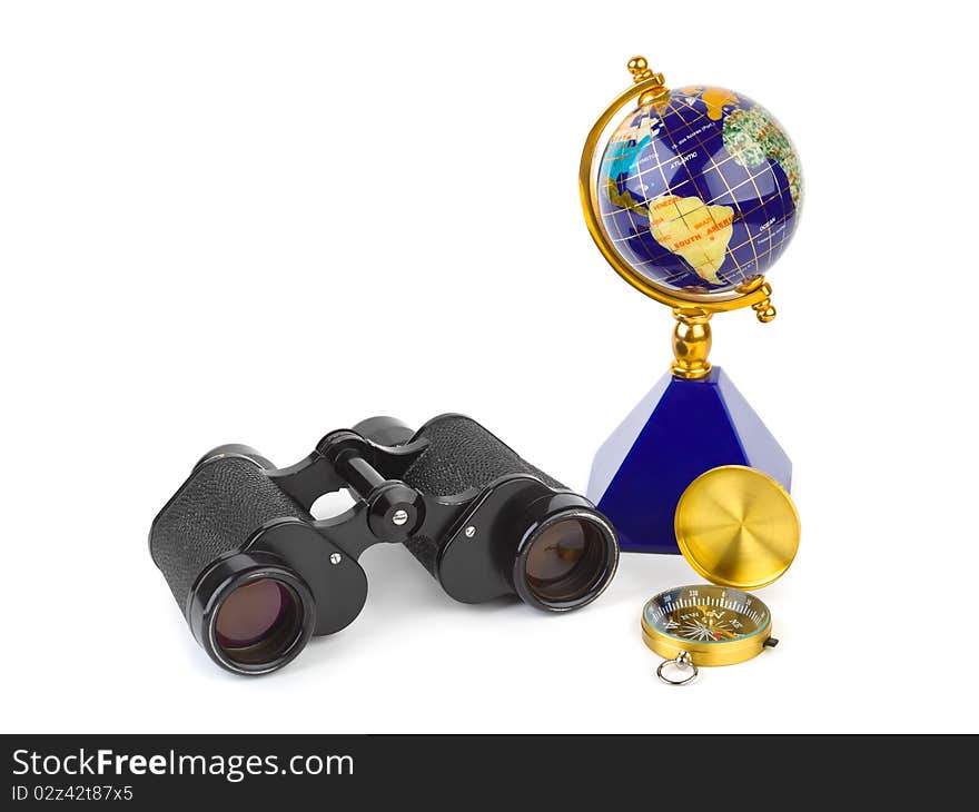 Binoculars, compass and globe - travel concept