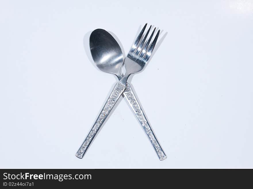 Spoon and fork on a white background.