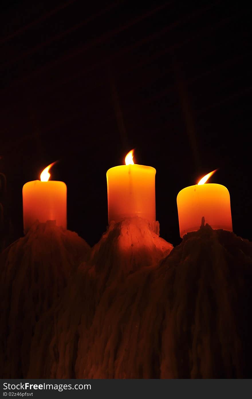 Tripple candle showing candlelight in the dark. Tripple candle showing candlelight in the dark