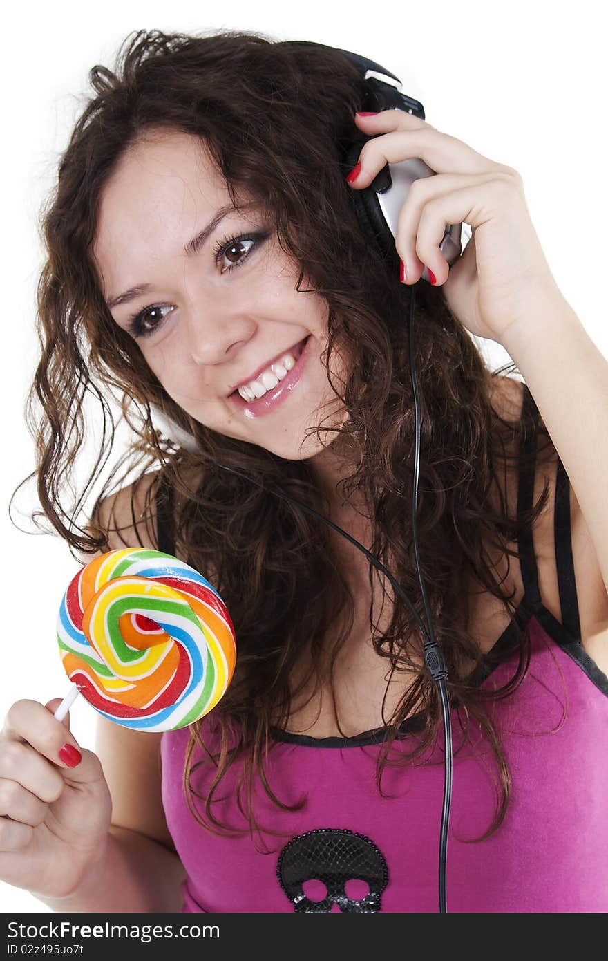 Girl in ear-phones dances and eats a lollipop