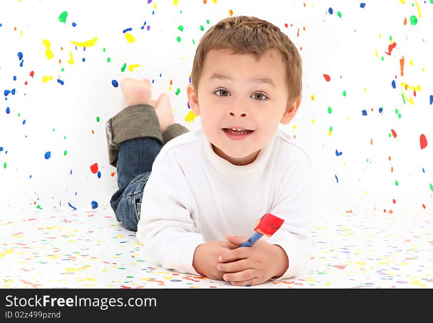 Adorable two year old toddler boy over paint splatter background in casual. Adorable two year old toddler boy over paint splatter background in casual.