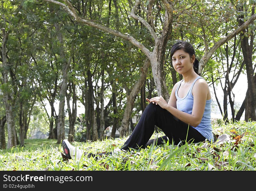 An Asian woman relaxing outdoors. An Asian woman relaxing outdoors