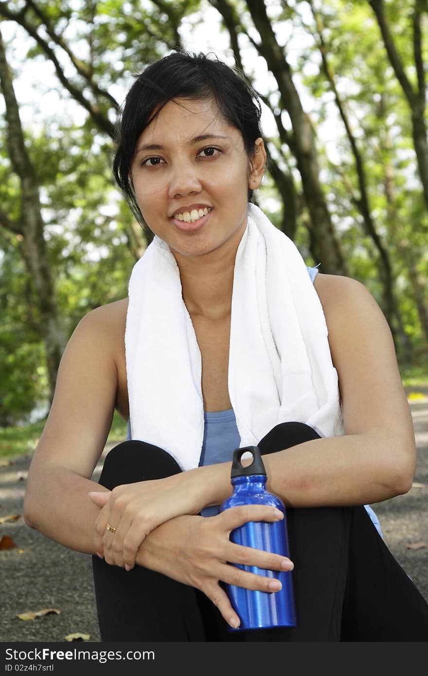 An Asian woman resting after a workout session