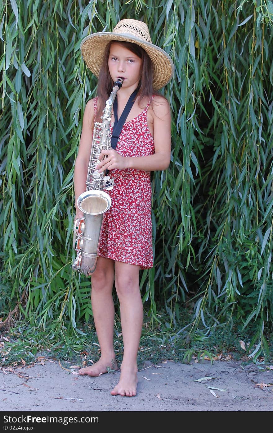 Girl with saxophone outdoor.Near Kiev,Ukraine