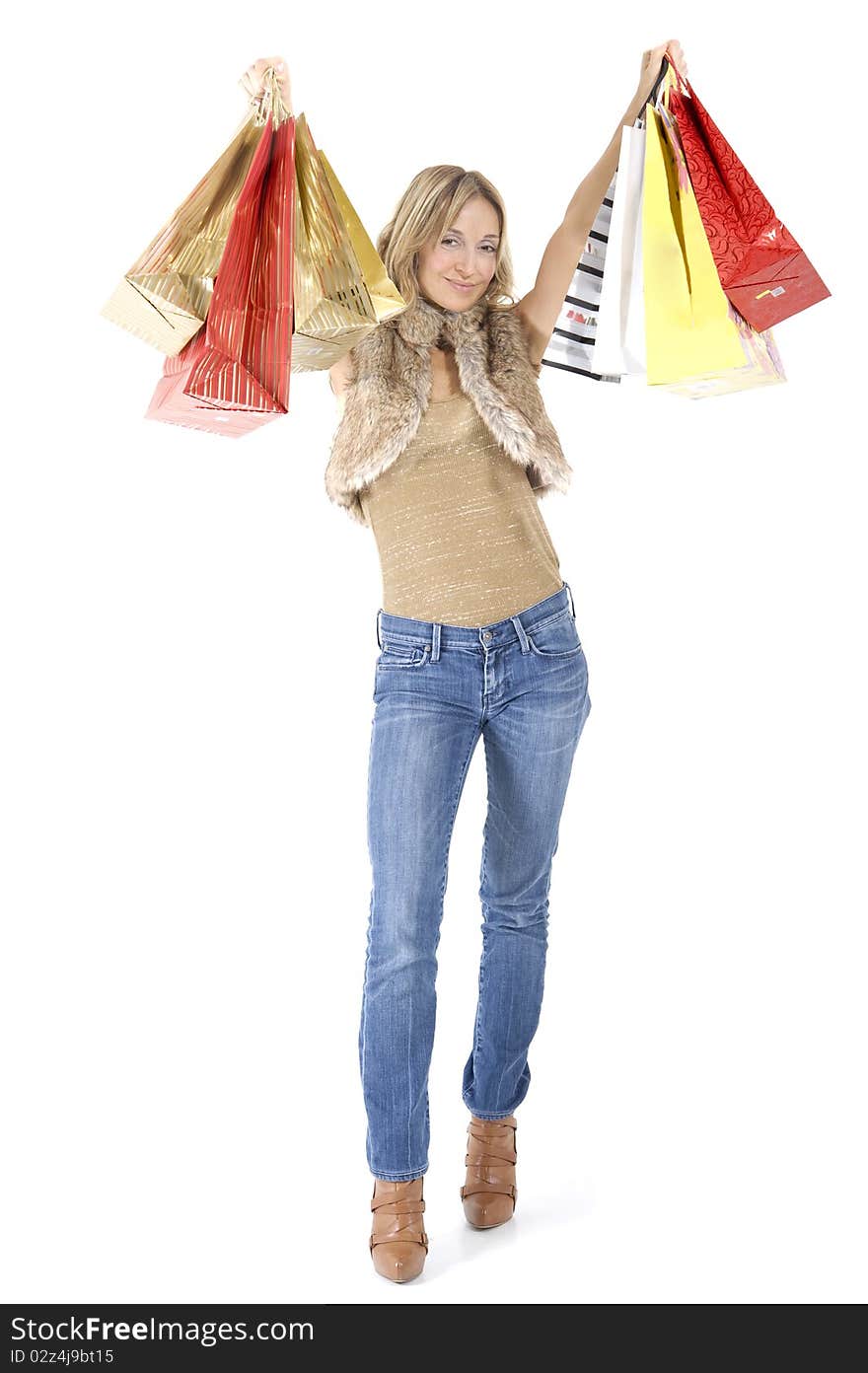 blond woman with shopping bags smiling happily. blond woman with shopping bags smiling happily