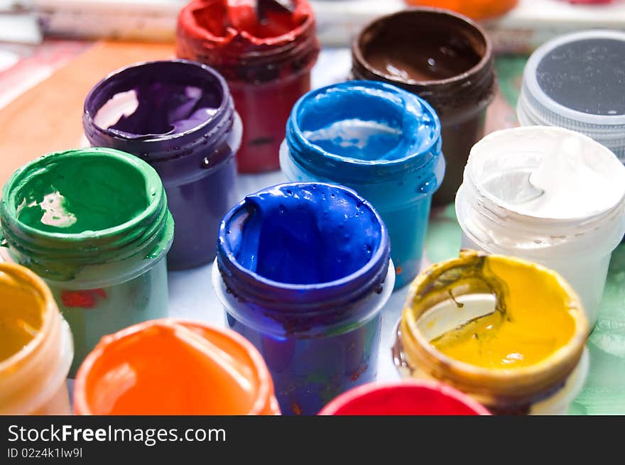 Closeup of open buckets with color paints, view from above. Closeup of open buckets with color paints, view from above