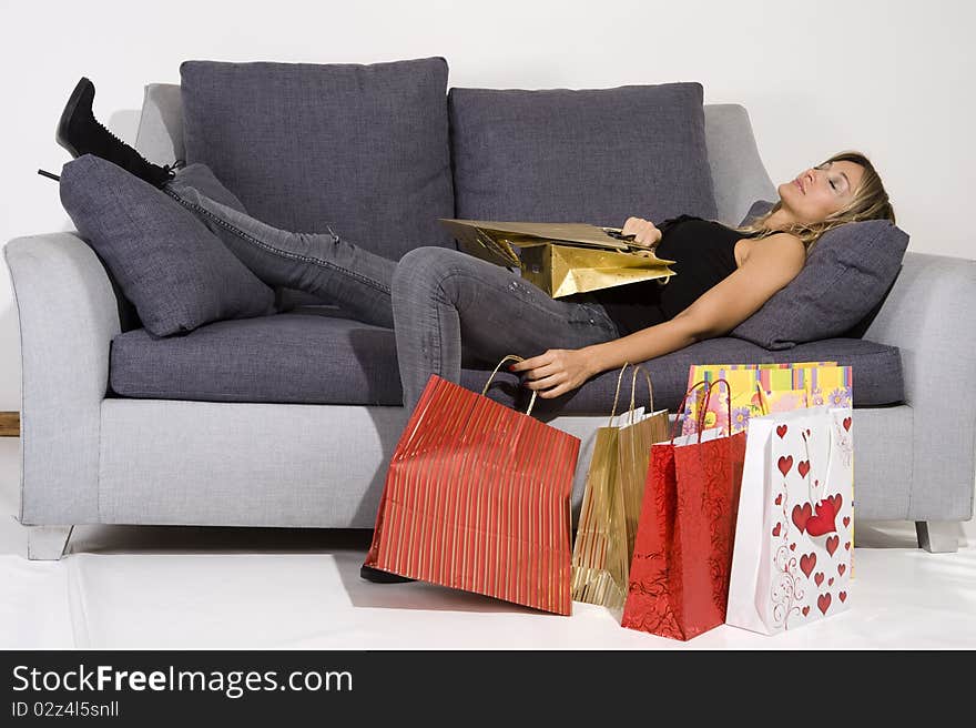 blond woman with shopping bags smiling happily. blond woman with shopping bags smiling happily