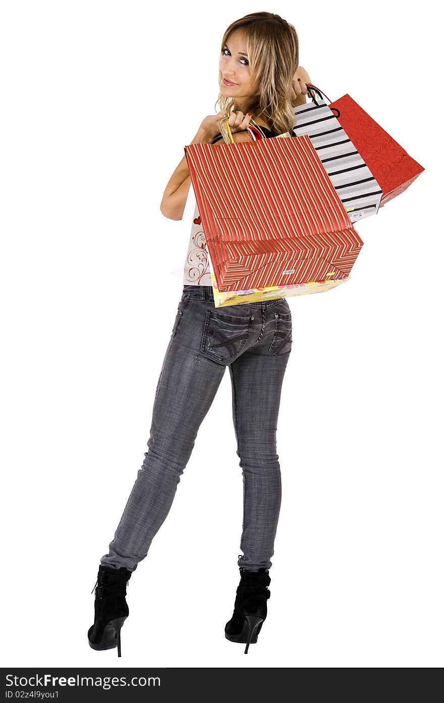 blond woman with shopping bags smiling happily. blond woman with shopping bags smiling happily