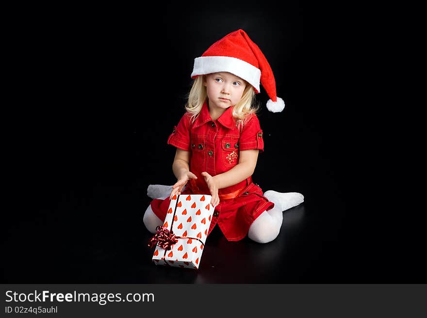 Surprised Girl In Santa Cap With Gift