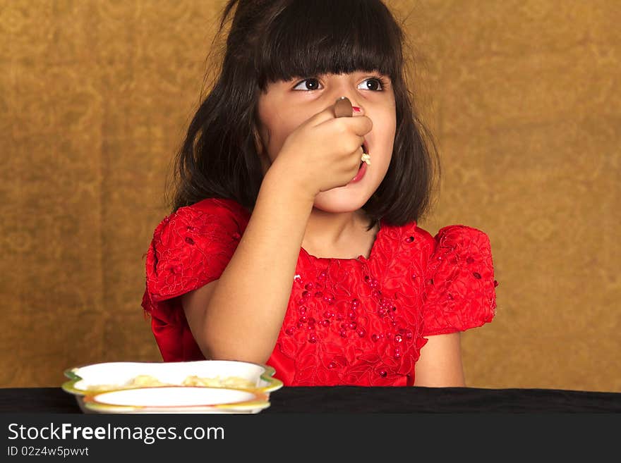 Beautiful Little girl eating spaghetti