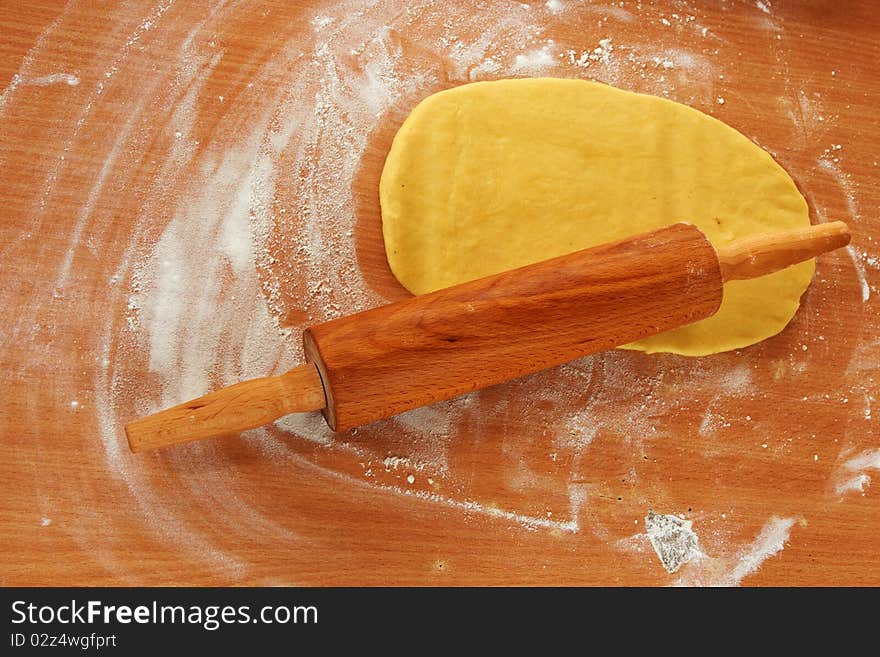 A dough with roller on a table