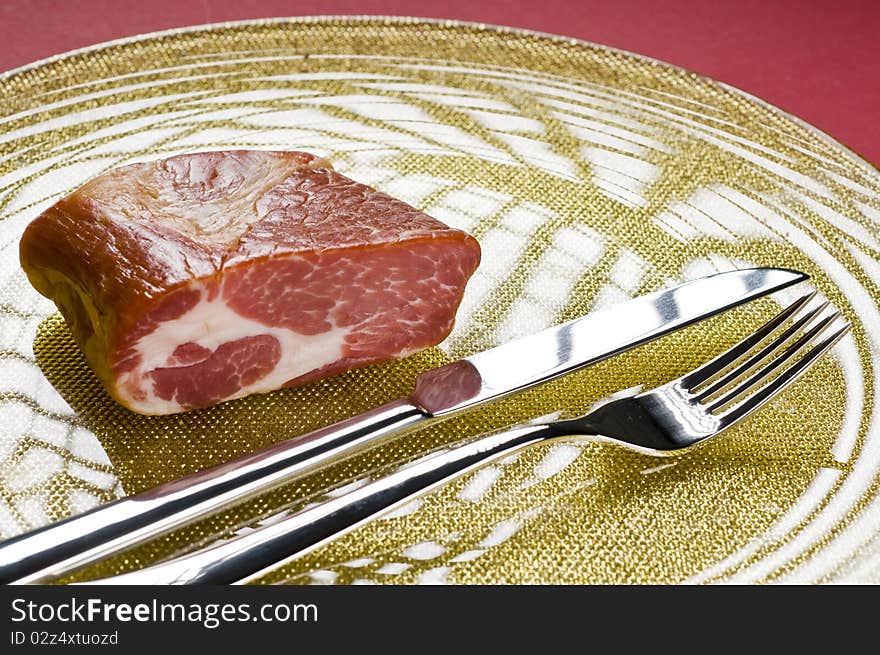 Raw meat on a plate over color background