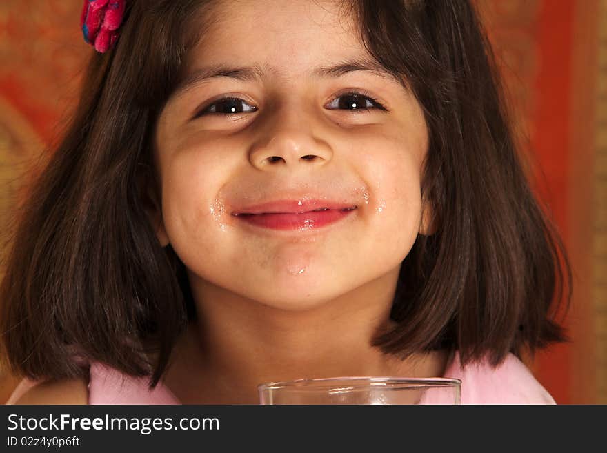 Little cute child drinking healthy mango juice