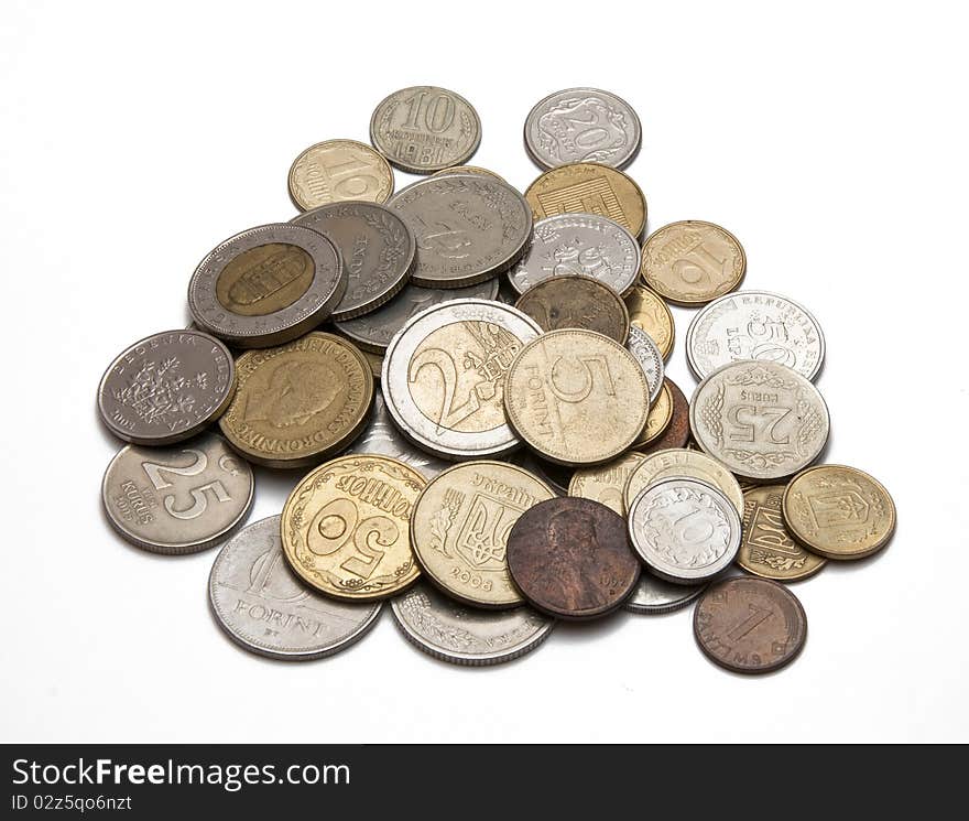 Coins from different countries on a white background