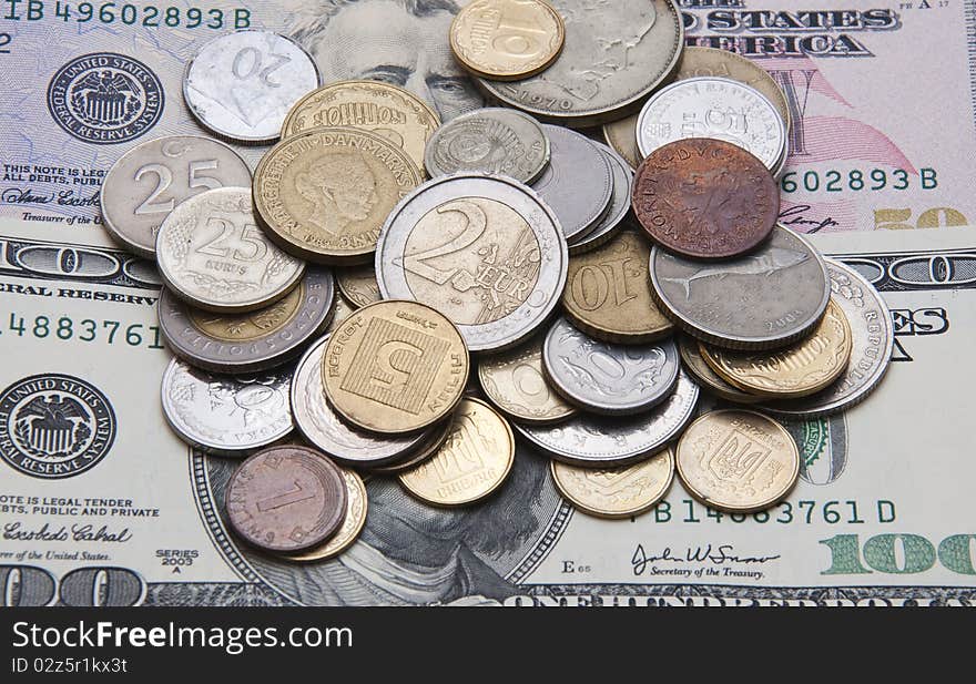 Coins of different countries lie on the dollar. Coins of different countries lie on the dollar