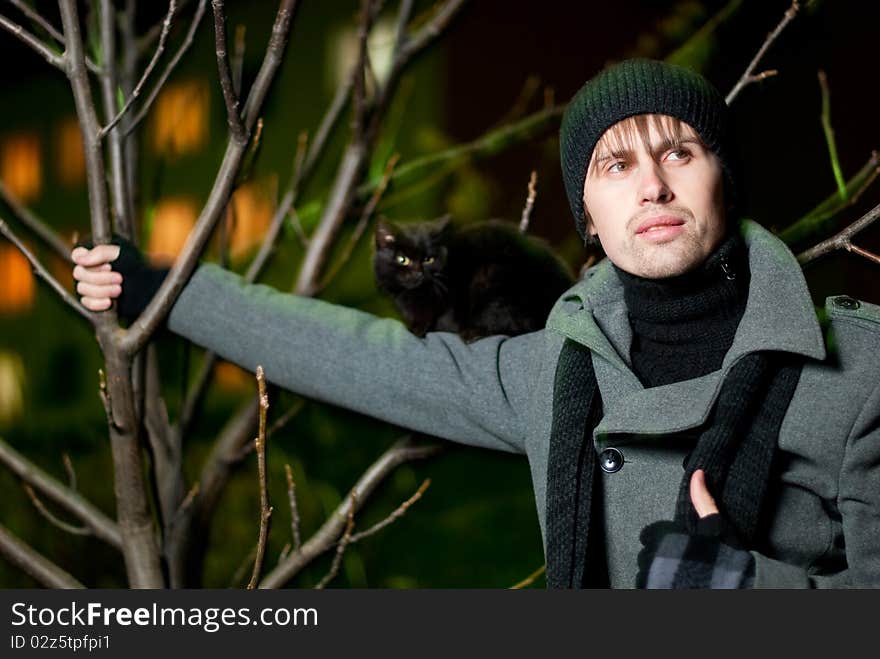 Young man with black cat on his shoulder. Young man with black cat on his shoulder