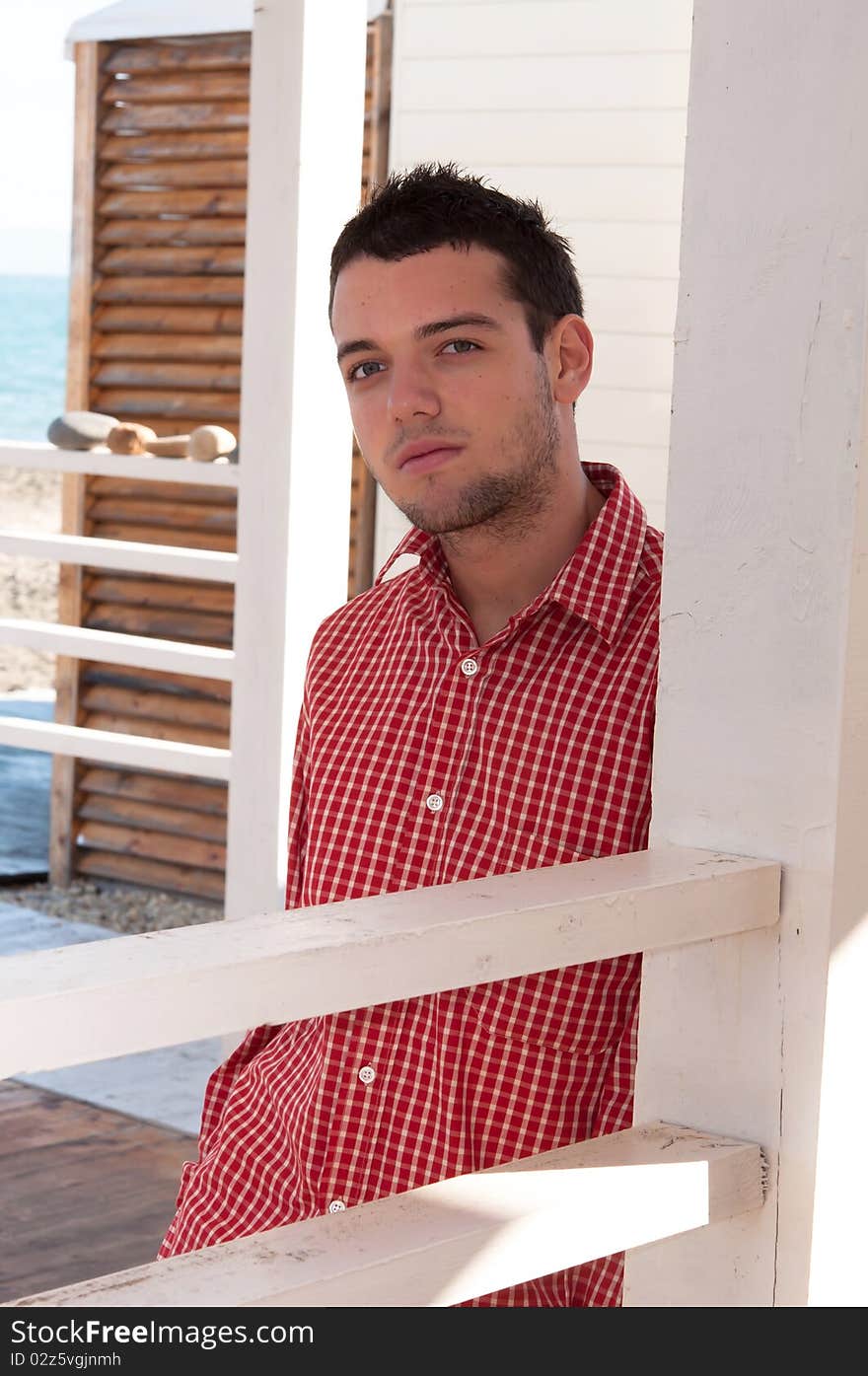 Young man in red shirt looking at camera. Young man in red shirt looking at camera