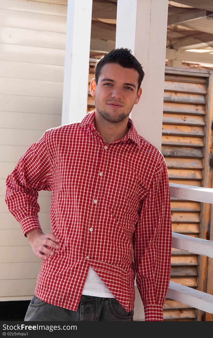 Young man in red shirt looking at camera. Young man in red shirt looking at camera