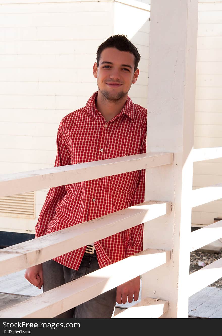 Young man in red shirt looking at camera. Young man in red shirt looking at camera