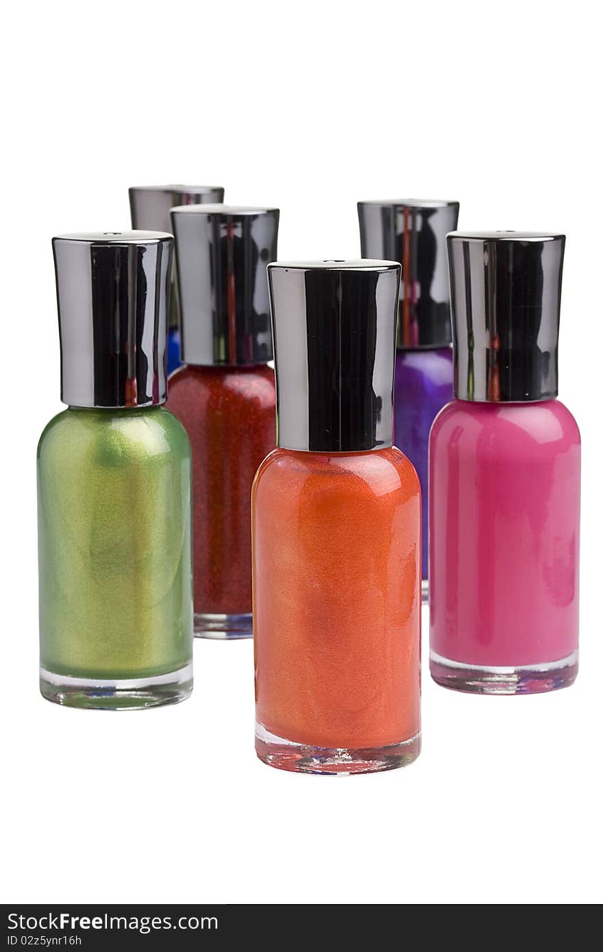 Different colored nail polish bottles placed in front of a white background.