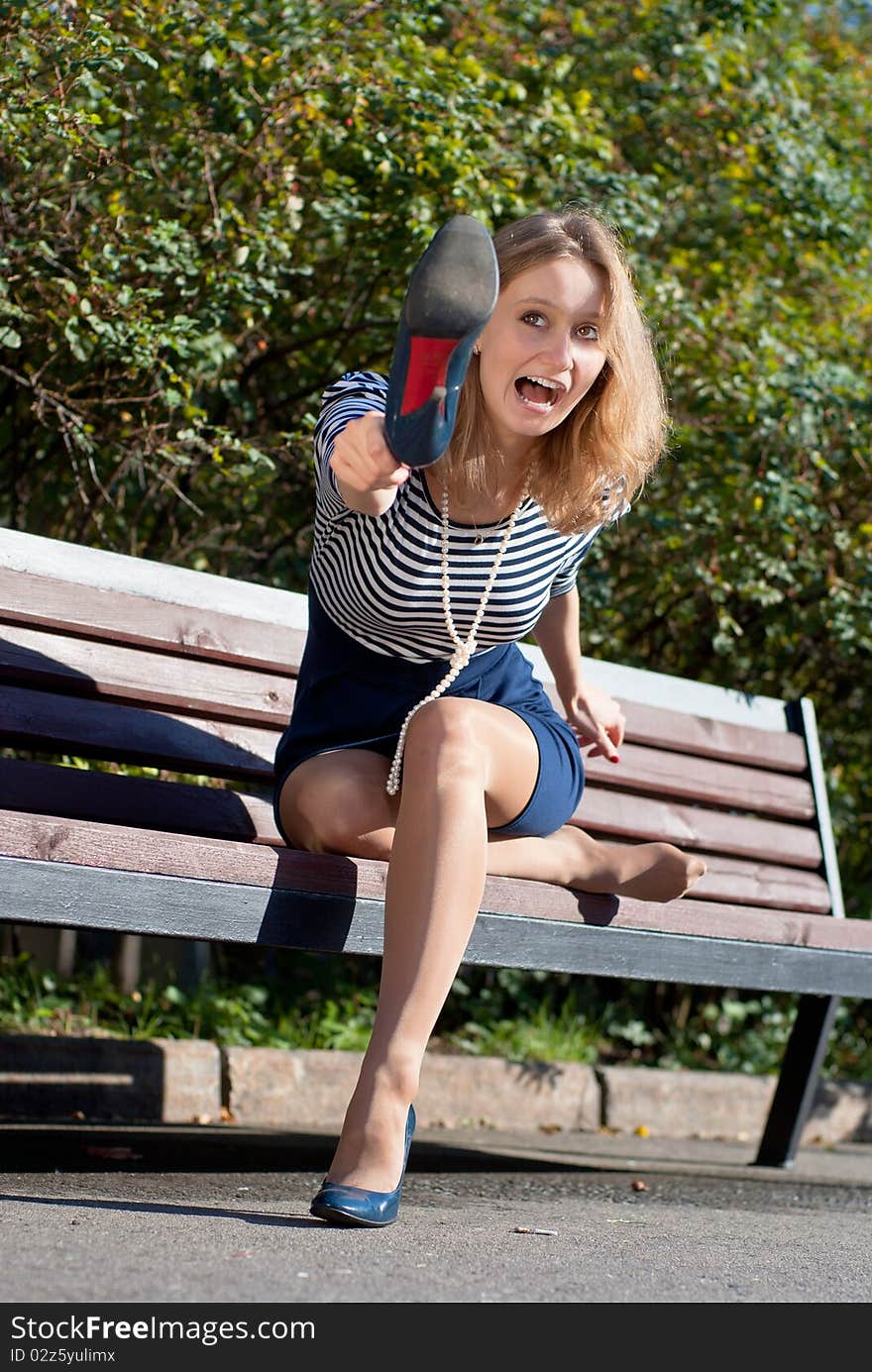 Portrait of a beautiful young woman in park sitting on the bench. Portrait of a beautiful young woman in park sitting on the bench