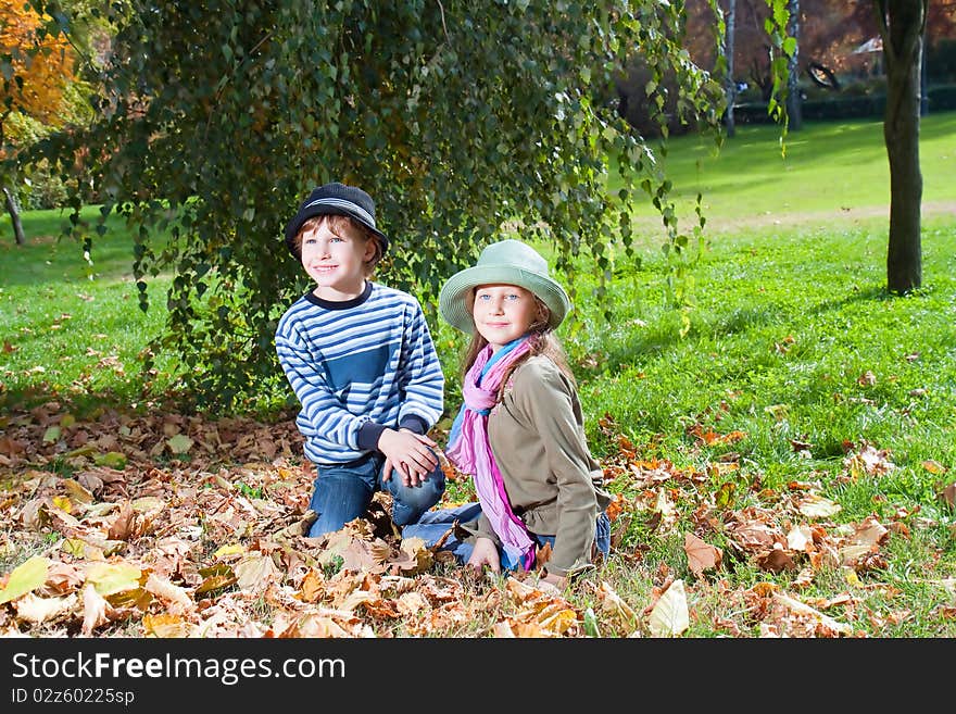 Happy Girl And Boy  Enjoying Golden Autumn