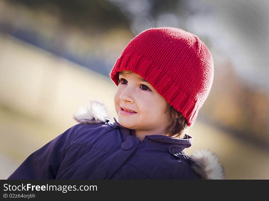 Portrait of a little girl in red hat smiling