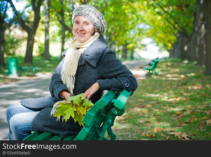 Pretty Young Woman Resting On A Bench