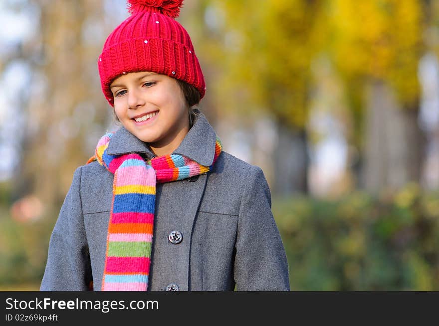 Little Miss. Pretty cute girl walks in autumn park