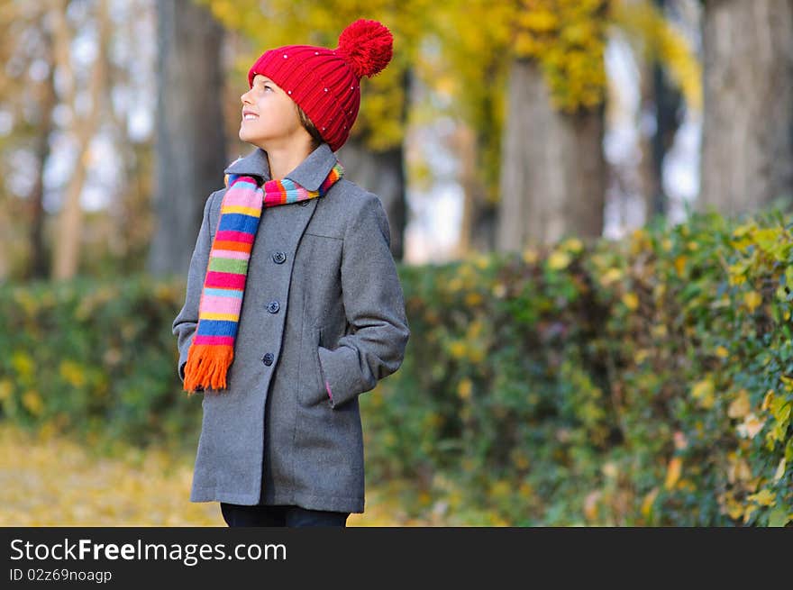 Little Miss. Pretty cute girl walks in autumn park