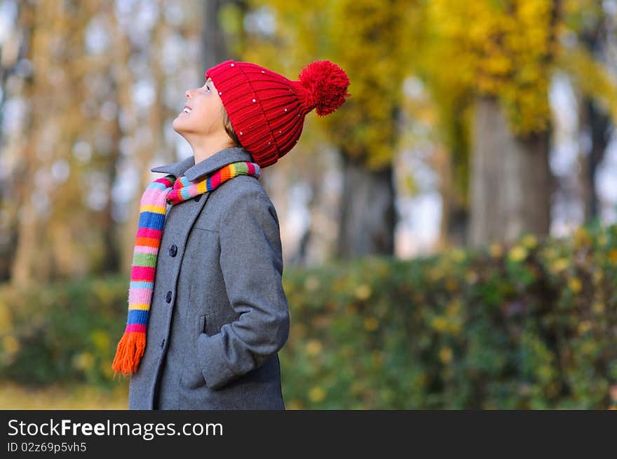 Little Miss. Pretty cute girl walks in autumn park