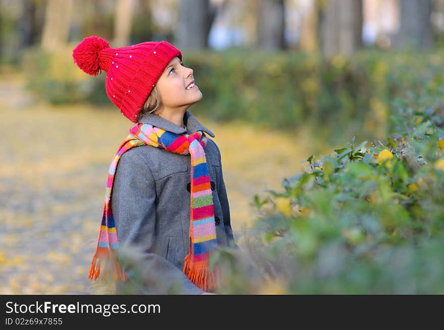 Little Miss. Pretty cute girl walks in autumn park