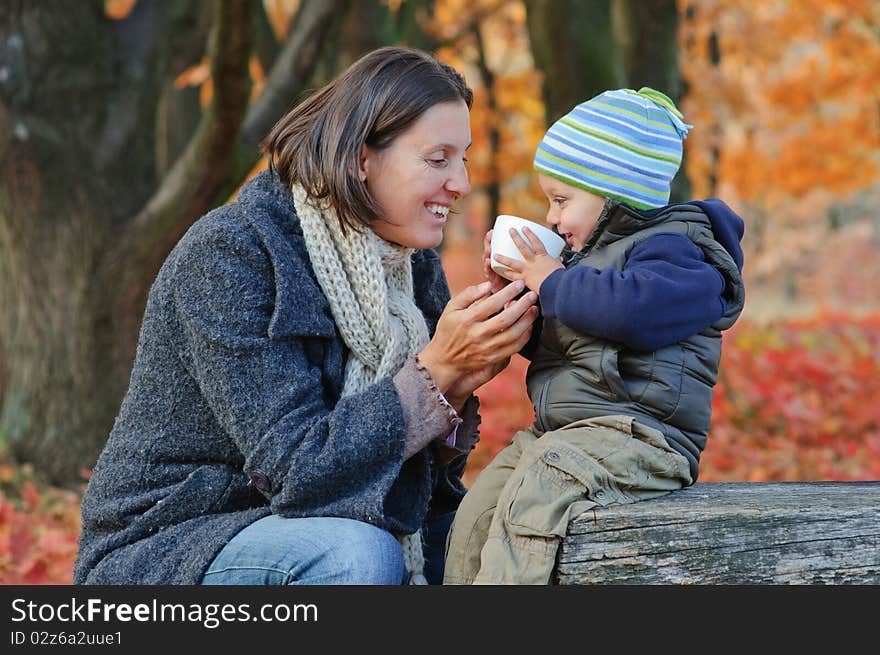 Little cute boy drinks tea with her mother