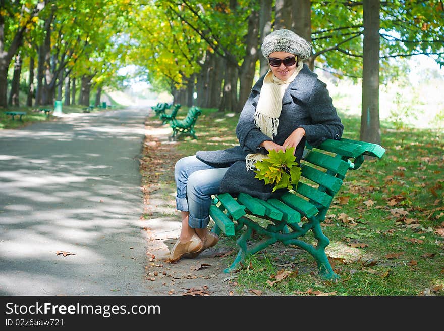 Pretty young woman resting on a bench