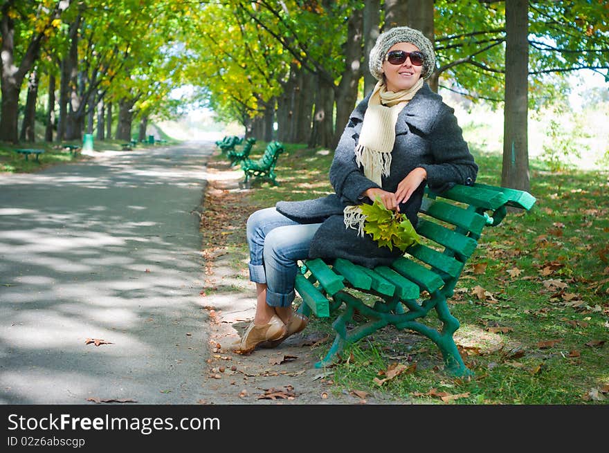 Pretty young woman resting on a bench