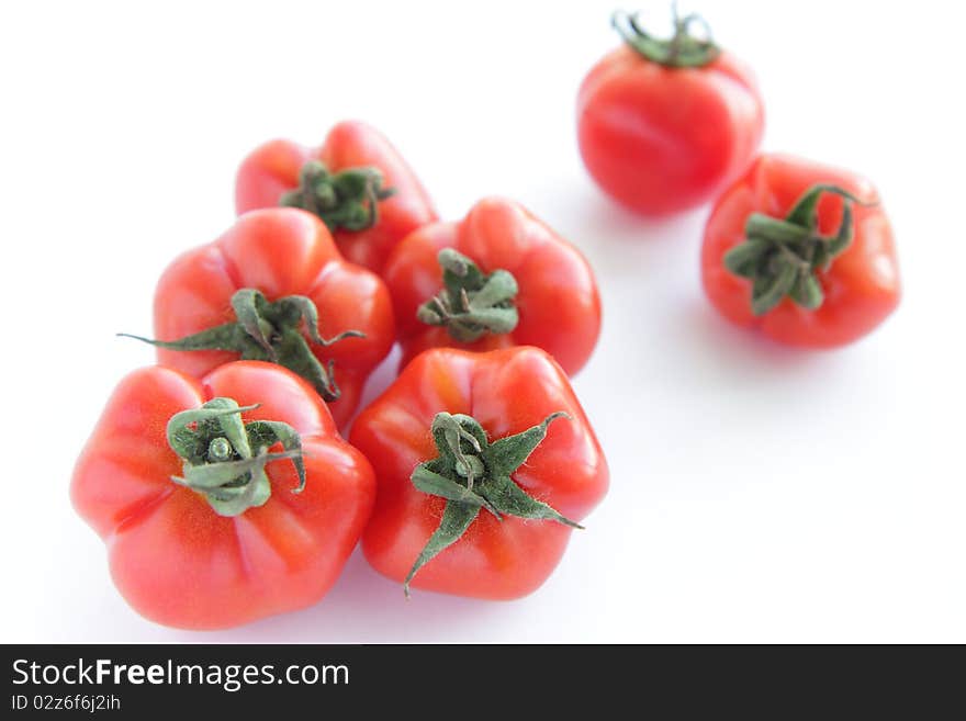 Ripe red tomatoes on white background