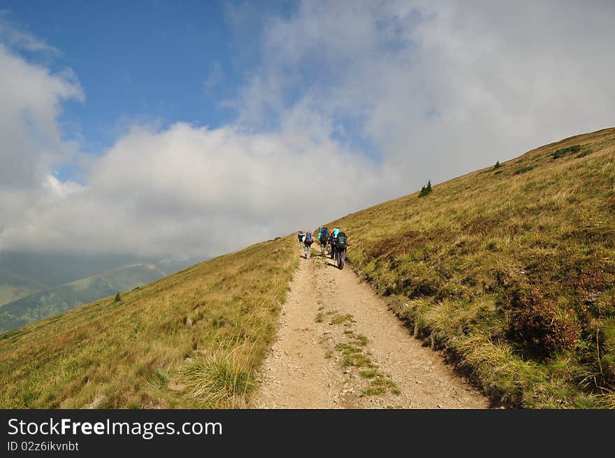 Tourists Moving In The Carpatian Mountains