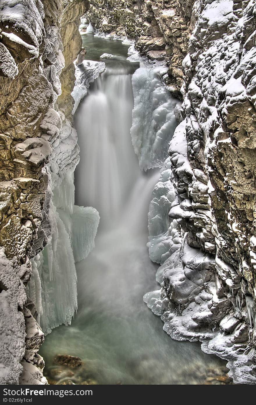 Water is running down the cold icy stonewall. Water is running down the cold icy stonewall