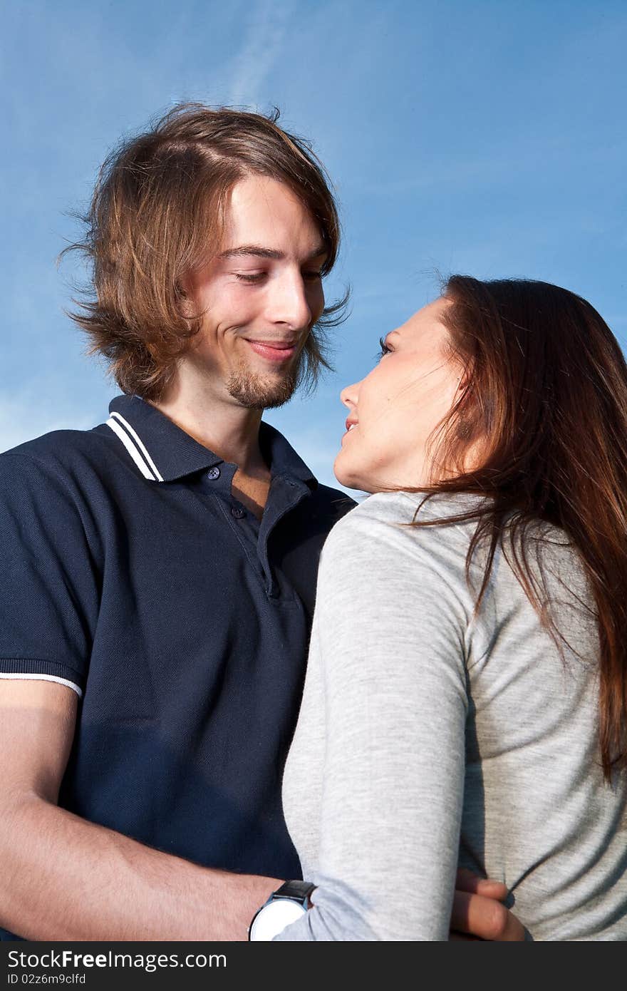 Young couple in love with blue sky in the background. Young couple in love with blue sky in the background