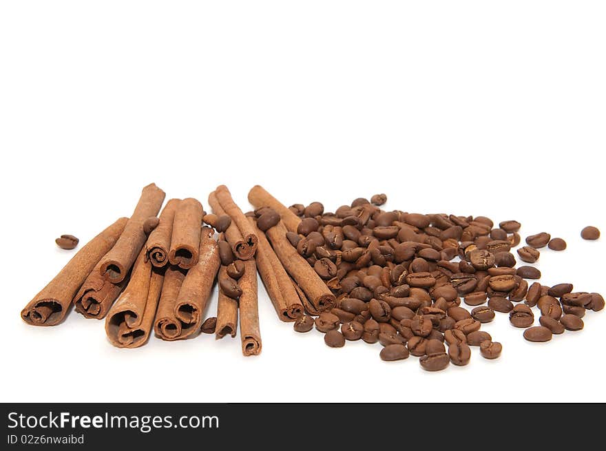 Cinnamon sticks and coffee beans on white background. Cinnamon sticks and coffee beans on white background