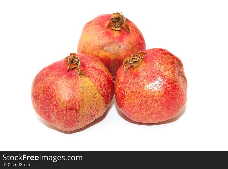 Three red pomegranates on white background. Three red pomegranates on white background