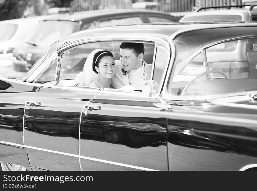 Newlywed couple, groom and bride, in car. Newlywed couple, groom and bride, in car